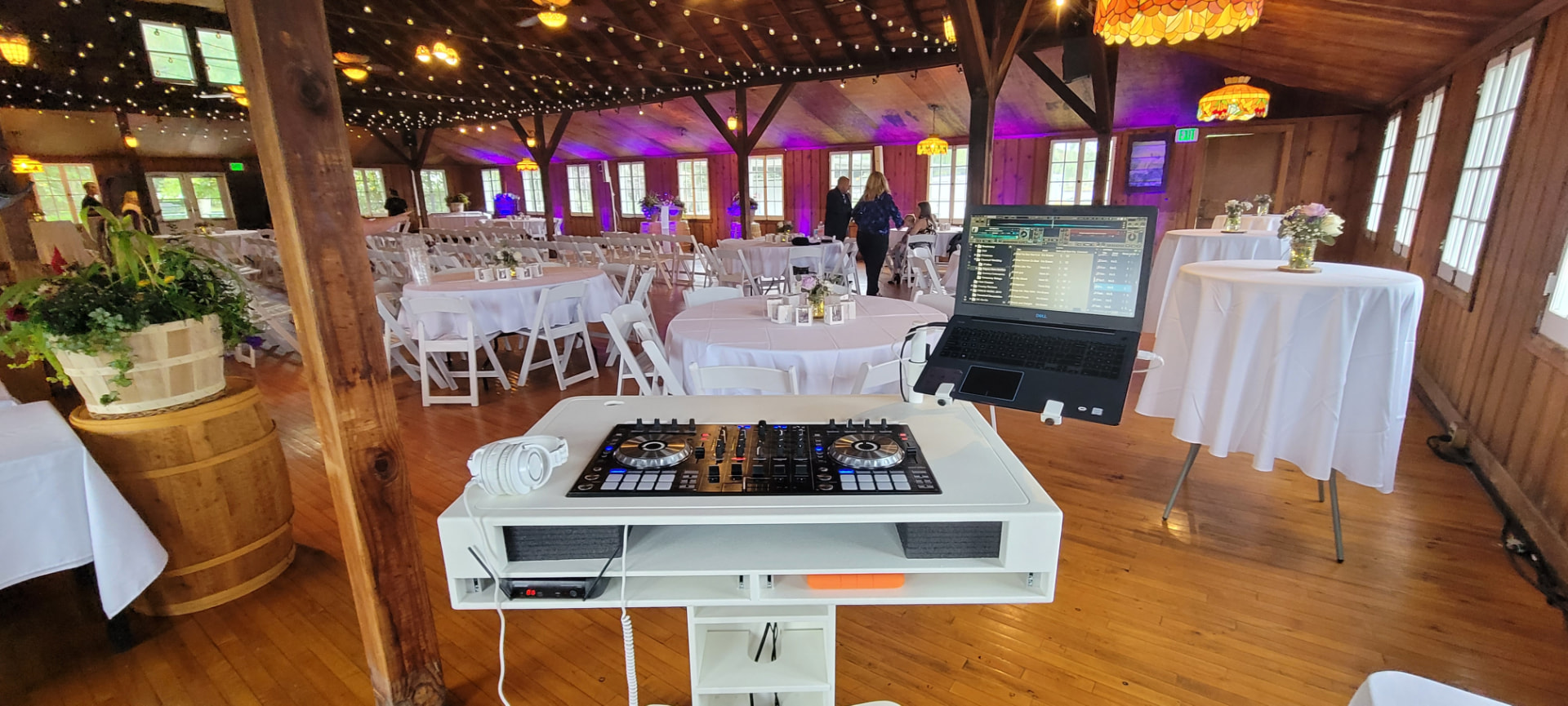 Barn reception setup with purple uplighting