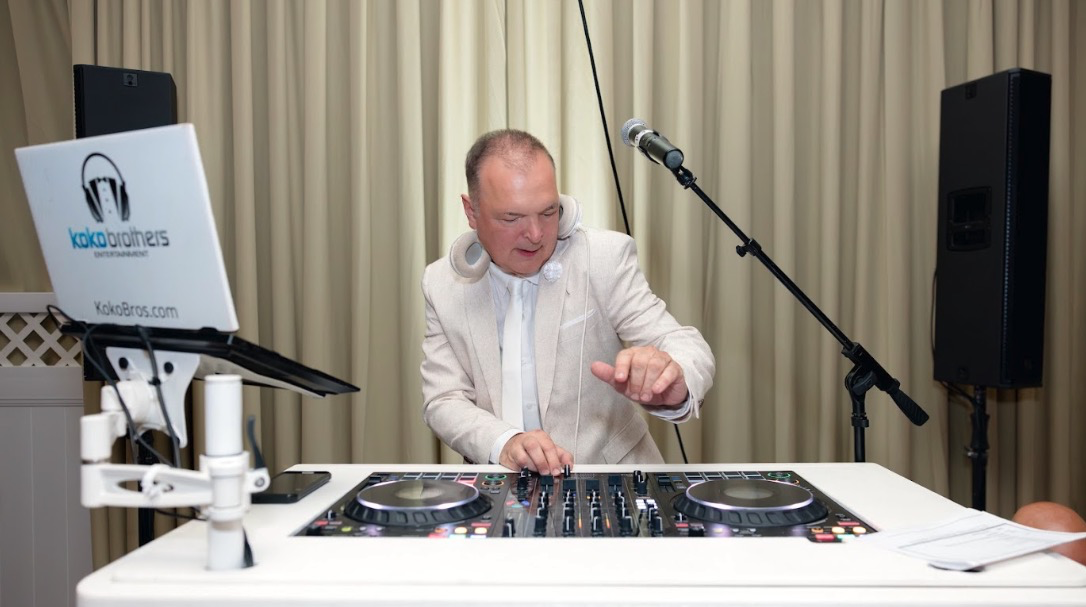 Lou Kokkinakos DJing at a formal event with Koko Brothers gear